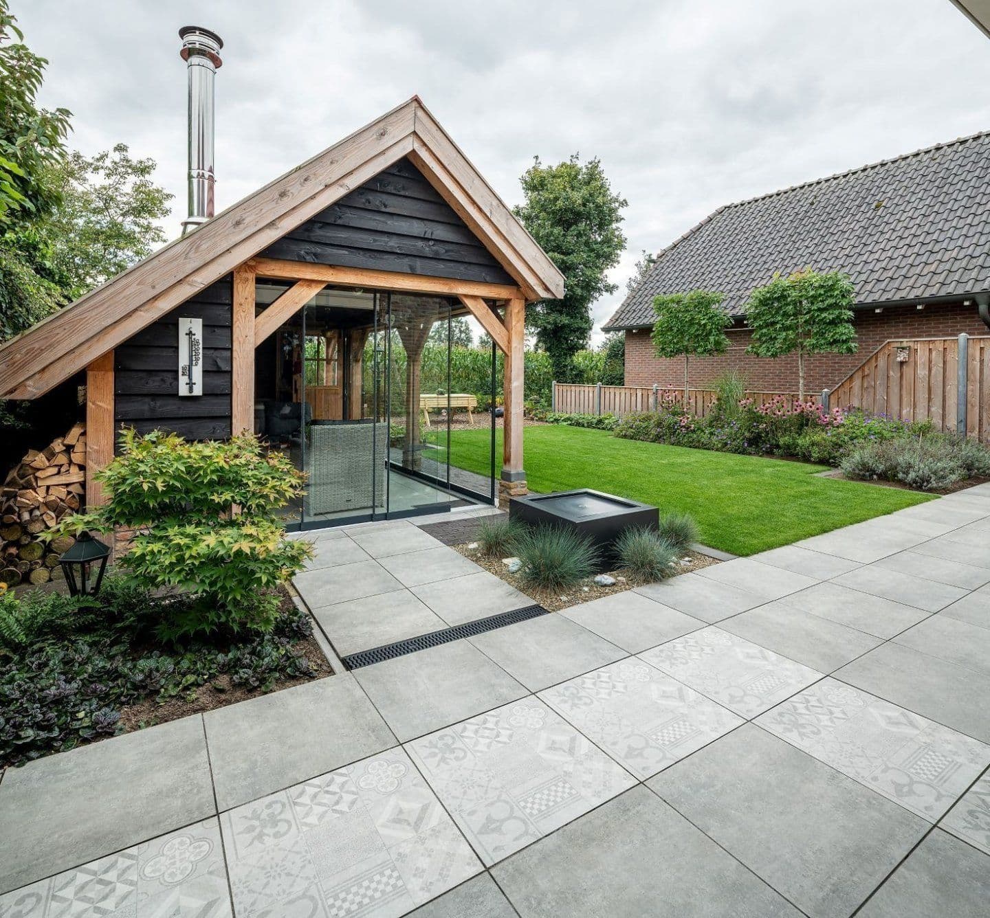 Professioneel tuinproject met tuinhuis, bestrating en gazon